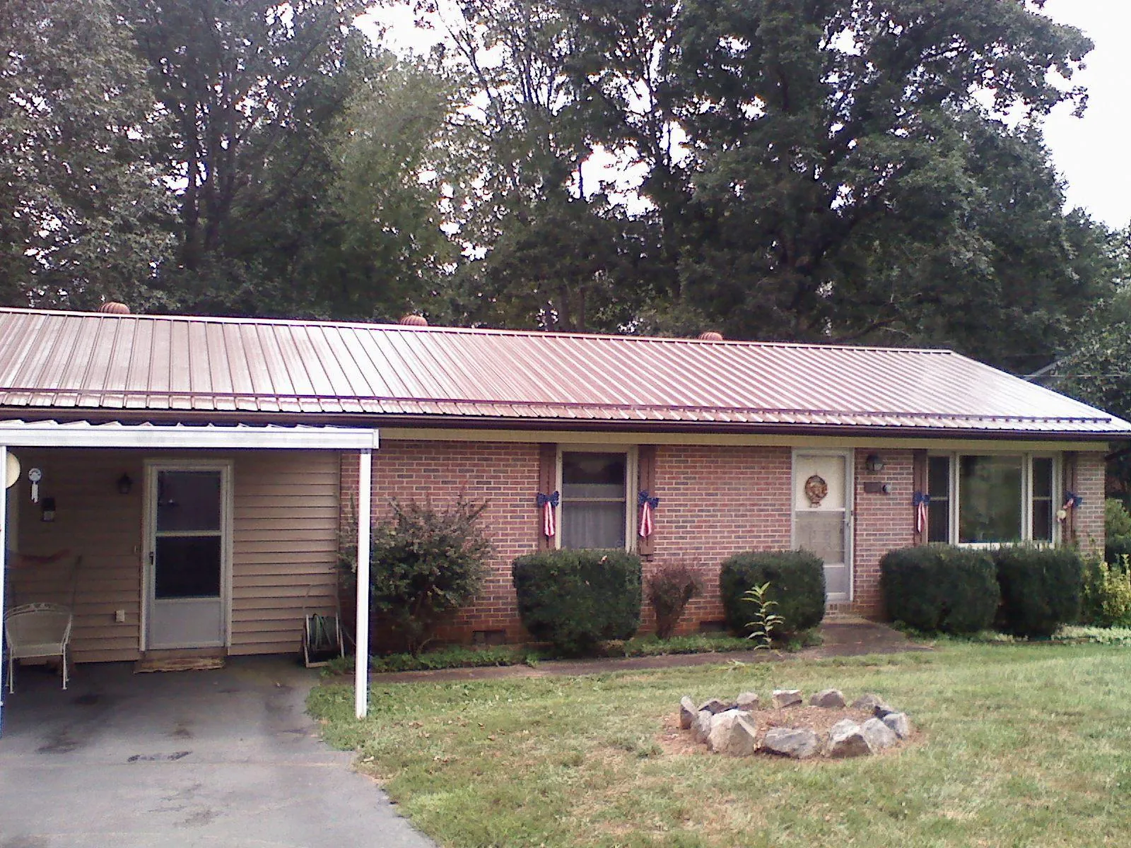 Bronze metal roof and carport on a brick ranch home in Sikeston
